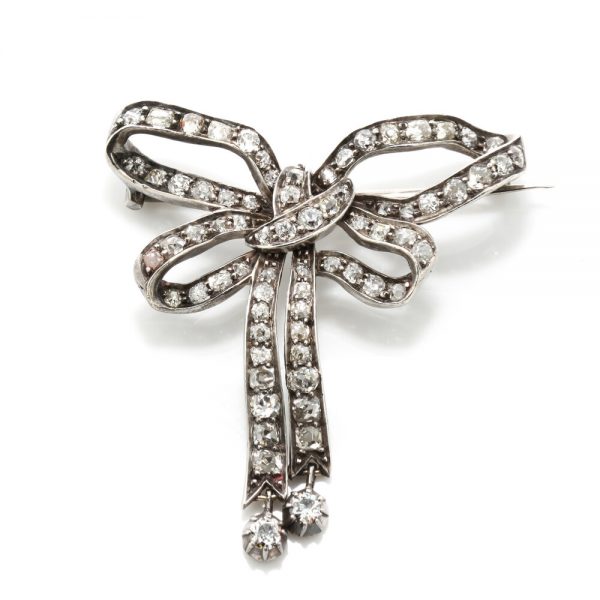 Antique Victorian Old Cut Diamond and Platinum Bow Brooch; set with 1.44 carats of old-cut diamonds, late 19th century Circa 1890s