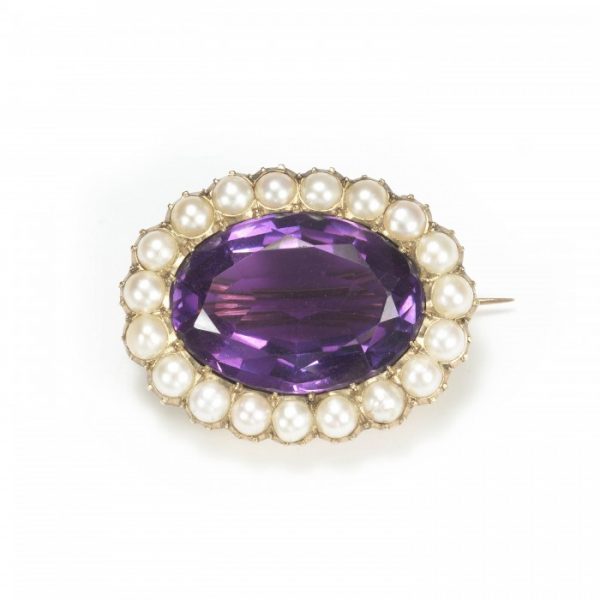 Antique Victorian Amethyst and Pearl Oval Cluster Brooch; oval-cut amethyst surrounded by a halo of white half-pearls, mounted in 15ct yellow gold