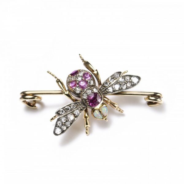 Antique Victorian Diamond, Ruby and Opal Bee Brooch; set with two opals for the eyes, round and cushion-shaped rubies and rose-cut diamonds to the body, and rose-cut diamonds in the wings, in silver and 18ct gold