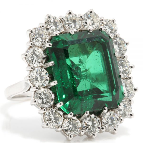 9ct Emerald Cut Natural Green Tourmaline and Diamond Cluster Ring; set with a large natural tourmaline surrounded by 2.40cts diamonds, in 18ct white gold