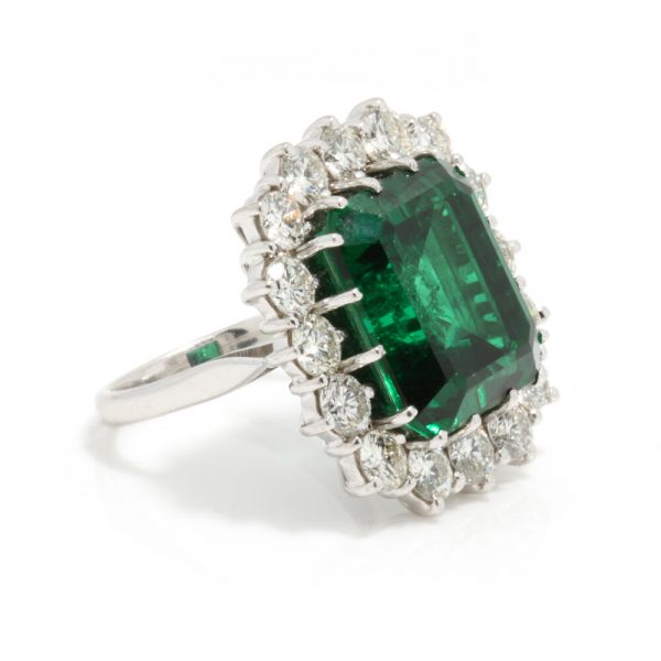 9ct Emerald Cut Natural Green Tourmaline and Diamond Cluster Ring; set with a large natural tourmaline surrounded by 2.40cts diamonds, in 18ct white gold