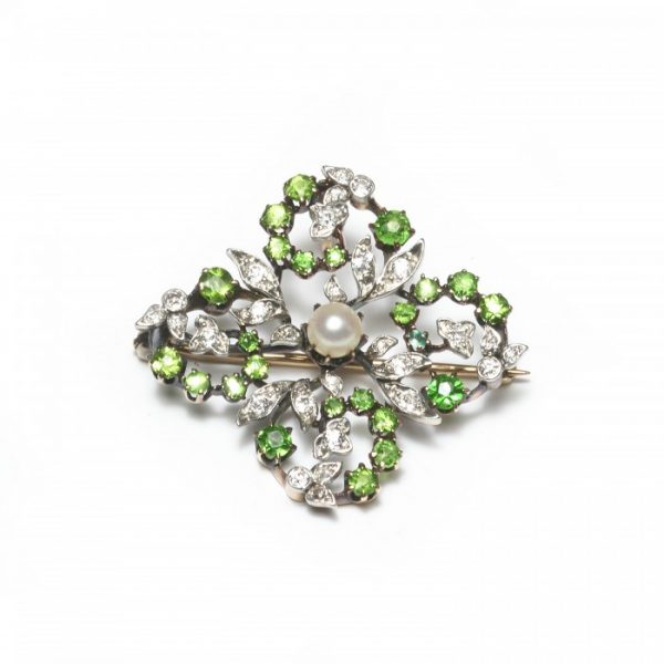 Antique Victorian Demantoid Garnet, Diamond and Pearl Brooch Pendant; round demantoid garnets and old cut diamonds set in an open quatrefoil design, with leaf motifs, around a central natural pearl