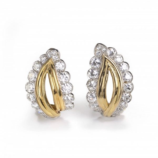 Vintage Gold, Platinum and Diamond Leaf Shaped Earrings; pair of yellow gold and platinum leaf-shaped stud earrings, cut-out centre section surrounded by a border of 3.50cts round brilliant-cut diamonds. Circa 1950s-1960s