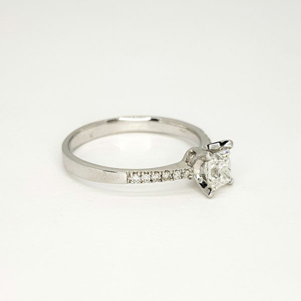 0.63ct Princess Cut Diamond Engagement Ring with Diamond Shoulders; central claw-set 0.63 carat princess-cut diamond, with diamond-set shoulders, in 18ct white gold
