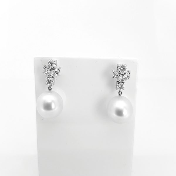 South Sea Pearl Drop Earrings with Diamond Tops; each earring featuring a lustrous Southsea pearl suspended from a diamond cluster, in 18ct white gold