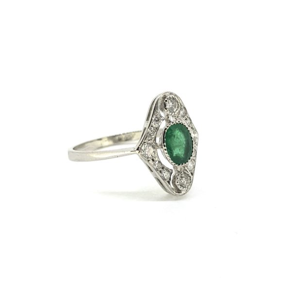 Art Deco Style Emerald and Diamond Cluster Ring in Platinum; central 0.60ct oval-cut emerald encompassed within a 0.30ct diamond-set surround