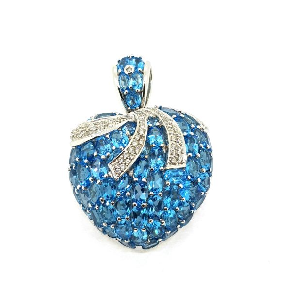 Blue Topaz and Diamond Heart Pendant; encrusted with oval cut topaz, accented with diamond set bow detailing, in 18ct white gold with decorative pierced back