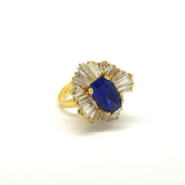 3.20ct Ceylon Sapphire and Baguette Diamond Ballerina Ring; central certified 3.20ct natural Ceylon Sapphire set above a skirt of tapering baguette diamonds, in 18ct yellow gold, with GCS certificate
