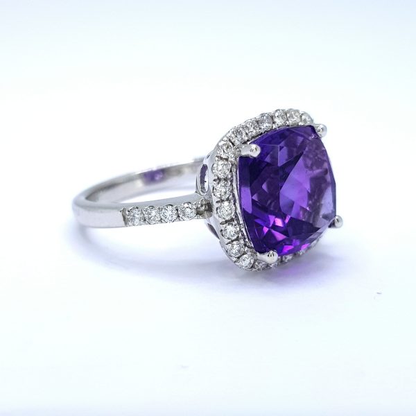 Contemporary Amethyst and Diamond Cluster Ring; central cushion-shaped mixed cut amethyst surrounded by diamonds, with diamond-set shoulders, in 18ct white gold