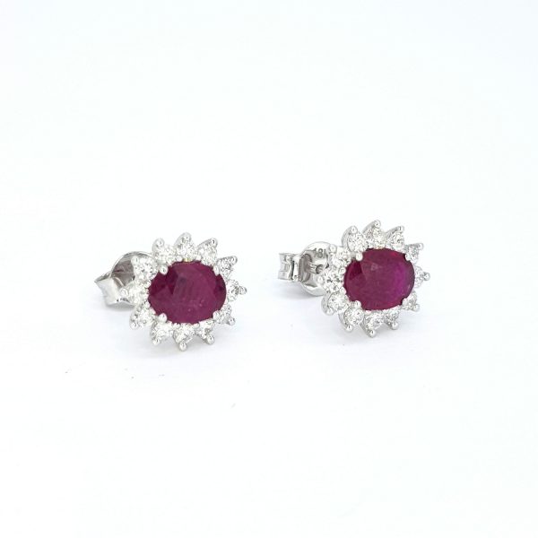 Ruby and Diamond Oval Cluster Stud Earrings; 1.62cts oval rubies surrounded by 0.62cts diamonds, in 18ct white gold