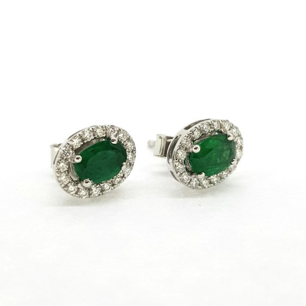 Emerald and Diamond Oval Cluster Stud Earrings; featuring 1.05cts oval cut emeralds within 0.25cts diamond surround, in 18ct white gold