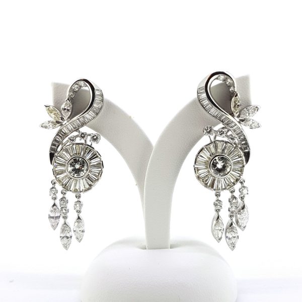 Vintage 1950s Scroll Diamond Drop Earrings, 6.00 carat total, central brilliant and baguette-cut diamond cluster decorated with a ribbon of baguette-cut diamonds swirl between three marquise diamond petals and three brilliant cut diamonds, with a waterfall of moving marquise and brilliant-cut diamond drops, in platinum