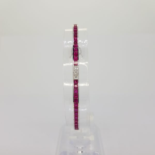 Princess Cut Ruby and Diamond Line Bracelet; 8.13cts princess-cut rubies accented with 1.05cts princess-cut diamond set sections, in 18ct white gold