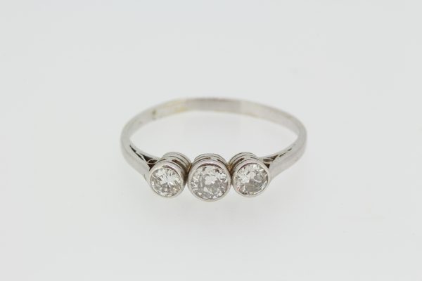Three Stone Diamond Ring in 18ct White Gold; An elegant diamond trilogy ring featuring three collet set diamonds in 18ct white gold