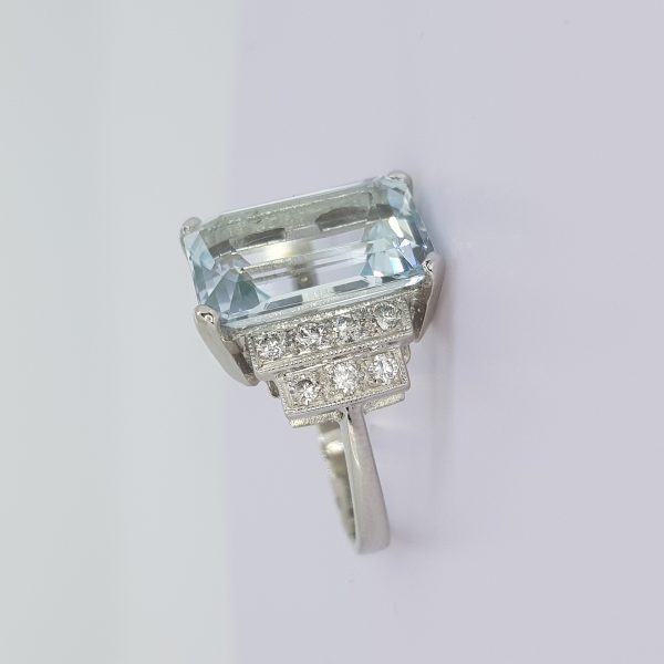 Emerald Cut Aquamarine and Diamond Dress Ring; large 6.50 carat emerald-cut aquamarine, claw set, with 0.45cts diamond-set stepped shoulders, in platinum