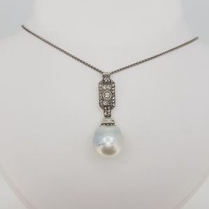 South Sea Pearl and Diamond Pendant; featuring a South Sea pearl suspended from a diamond-set geometric drop, in 18ct white gold