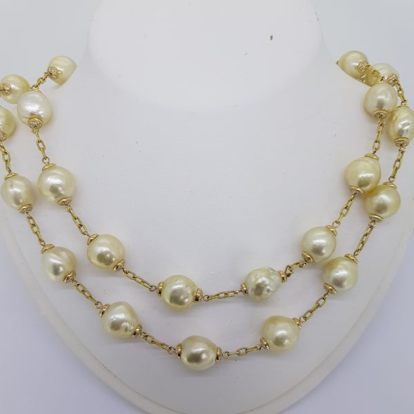 South Sea Pearl and Diamond Necklace; 31 baroque golden South Sea Pearls interspaced with 18ct yellow gold trace chains set with 4.40cts diamonds
