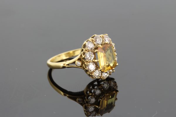 Yellow Sapphire and Diamond Cluster Ring in 18ct Yellow Gold; 1.90ct emerald-cut yellow sapphire surrounded by 1.40cts diamonds, with diamond-set split shoulders