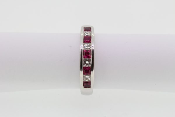 Princess Cut Ruby and Diamond Half Eternity Ring; channel-set with alternating square-cut rubies and princess-cut diamonds, in 18ct white gold
