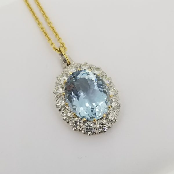 Aquamarine and Diamond Oval Cluster Pendant; large 7 carat oval faceted aquamarine surrounded by 1.84cts brilliant-cut diamonds, in 18ct white and yellow gold