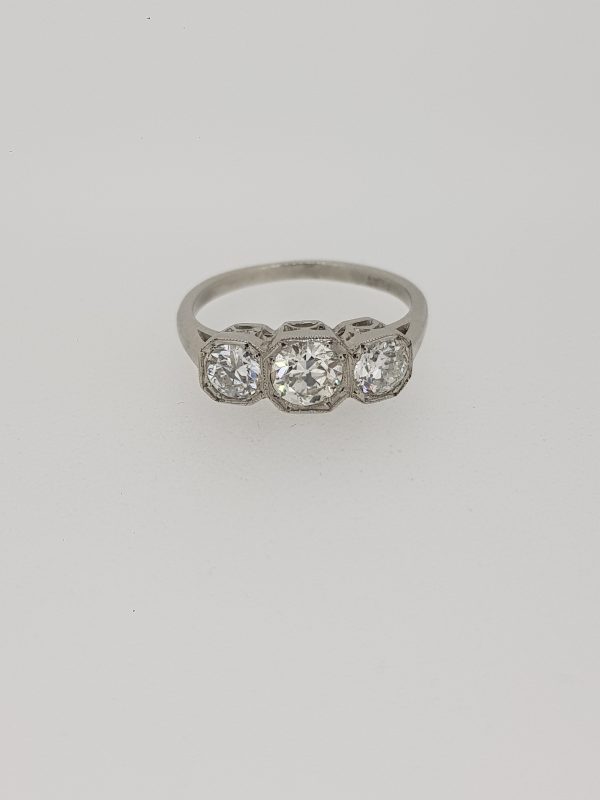 Diamond Three Stone Ring in Platinum, 1.25 carat total, featuring three diamonds set in square collets with delicate millegrain edging