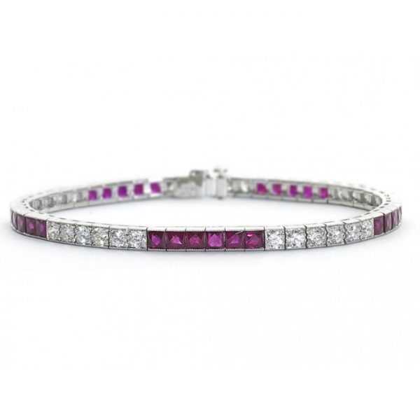 French Cut Ruby and Diamond Line Bracelet in Platinum; set with 2.55cts round brilliant cut diamonds and 23.50cts French-cut rubies, in millegrain edged box settings