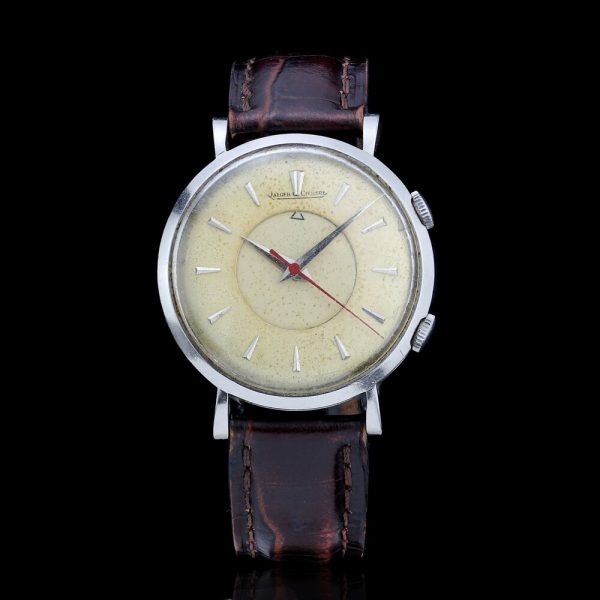 Jaeger LeCoultre Vintage Alarm Watch; cream dial with tapered baton hour markers, manual winding movement, on a brown leather strap. Circa 1960s