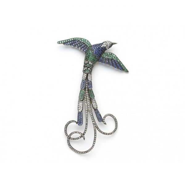 Sapphire, Emerald and Diamond Bird Brooch; striking bird of paradise brooch pavé set with sapphires, emeralds and diamonds, accented with ruby eyes, in silver upon gold