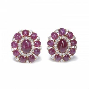 Vintage Cabochon Ruby and Diamond Cluster Earrings; 3.60ct oval cabochon-cut rubies surrounded rubies and diamonds, 18ct yellow gold, Circa 1970. Rubies 25.25cts, Diamonds 2.90cts