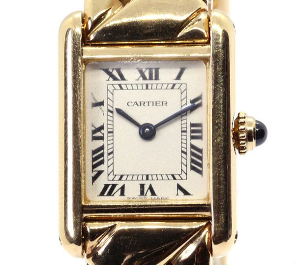 Cartier Tank Louis 18ct Yellow Gold Ladies Quartz Watch; white dial with Roman numerals, inner minutes track, sapphire crystal, blue cabochon gem set crown, on 18ct yellow gold bracelet with Cartier double deployant clasp, with a Cartier box