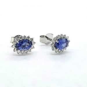 Sri Lanka Sapphire and Diamond Oval Cluster Earrings; 1.16cts oval sapphires surrounded by 0.28cts G colour diamonds, in 18ct white gold