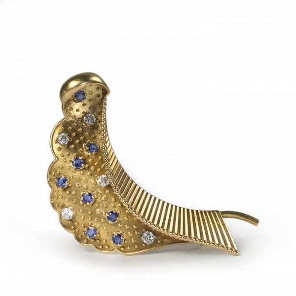 Cartier Vintage Sapphire Diamond and Gold Brooch; stylised folded leaf decorated with gold studs, brilliant diamonds and sapphires, Circa 1960