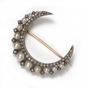Antique Victorian Natural Pearl and Rose Cut Diamond Crescent Brooch; set with graduated natural pearls accented with rose cut diamonds, in silver-upon-gold, Circa 1890