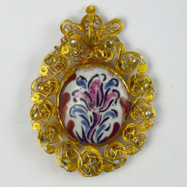Antique Devotional Saint Joseph Yellow Gold Pearl Enamel Pendant; depicting Saint Joseph in painted enamel with lily to reverse, surrounded by curled high carat yellow gold set with 26 drilled natural pearls, Circa 17th century