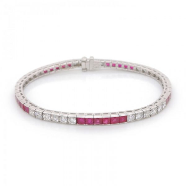 French Cut Ruby and Diamond Line Bracelet in Platinum; set with 2.55cts round brilliant cut diamonds and 23.50cts French-cut rubies, in millegrain edged box settings