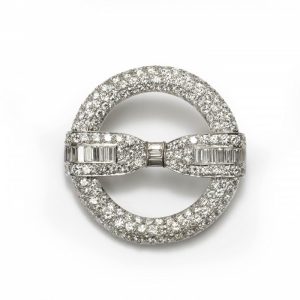 Art Deco Diamond Circle and Bow Brooch in Platinum, 6.50 carat total, baguette and brilliant cut diamond bow sits across an open pave diamond circle