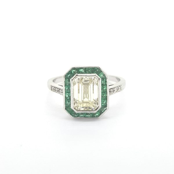 Contemporary 1.61ct Emerald Cut Diamond and Calibre Emerald Cluster Ring