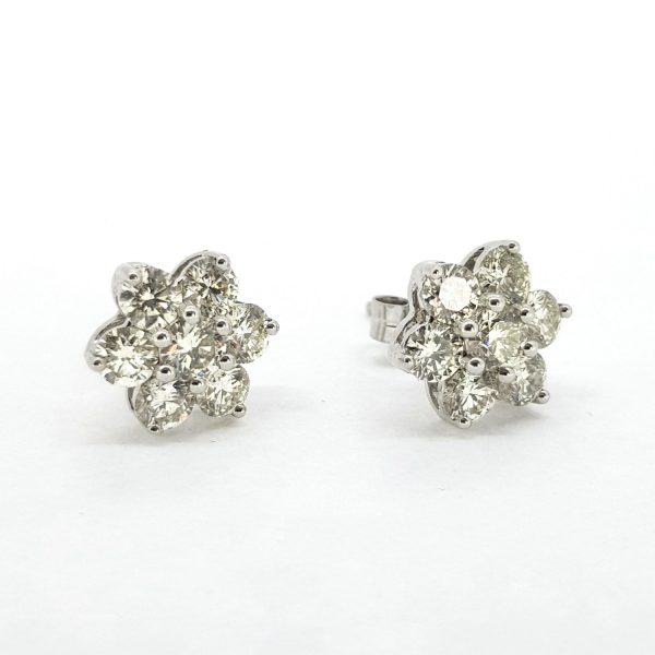 Diamond Star Stud Earrings, 2.20 carat total, each earring features seven claw-set brilliant-cut diamonds arranged in a star design, in 18ct white gold