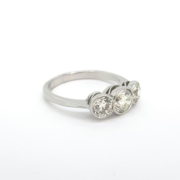 Diamond Three Stone Ring in Platinum, 1.75 carat total, modern diamond trilogy ring featuring three collet-set round brilliant-cut diamonds