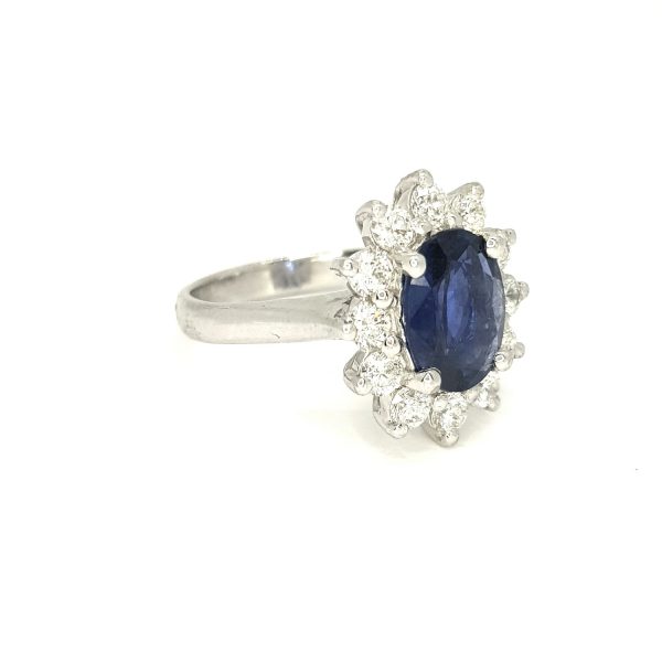 Sapphire and Diamond Cluster Ring; central 2.57ct oval faceted sapphire surrounded by 1.08cts sparkling diamonds, in 18ct white gold