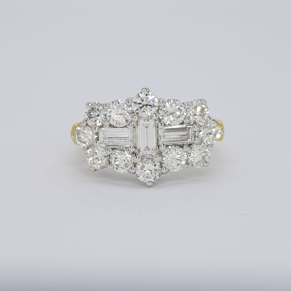 Baguette and Brilliant Cut Diamond Cluster Ring; three central baguette-cut diamonds within a brilliant-cut diamond surround, 18ct yellow gold