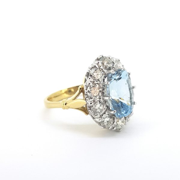 Aquamarine and Diamond Cluster Ring; central 3.80 carat aquamarine surrounded by 2cts diamonds, in 18ct gold