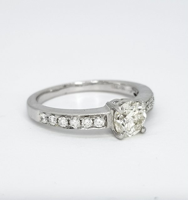 0.70ct Diamond Solitaire Engagement Ring with Diamond Shoulders; central 0.70ct brilliant-cut diamond flanked by diamond-set shoulders, in 18ct white gold