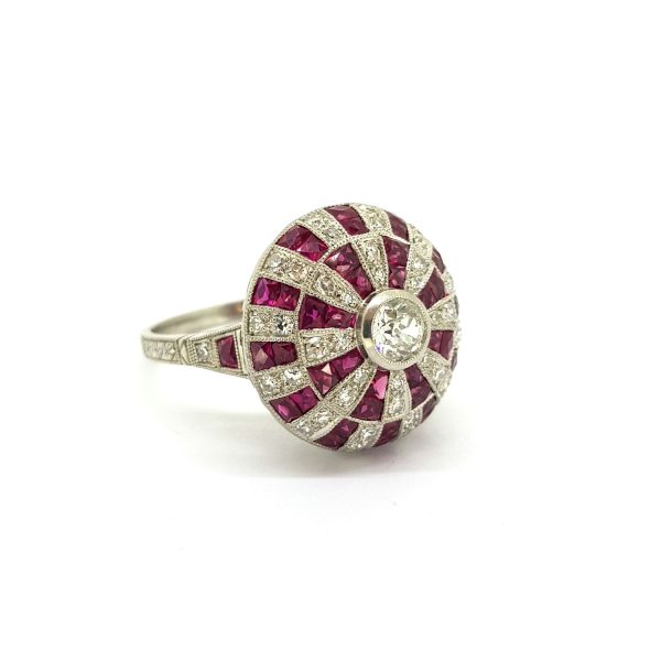 Ruby and Diamond Cluster Bombe Cocktail Ring; calibre cut rubies and brilliant-cut diamonds in platinum in the Art Deco style