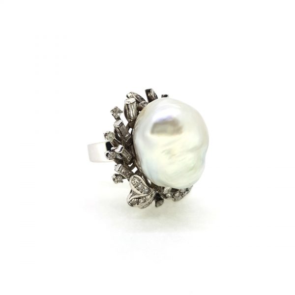Contemporary South Sea Pearl and Diamond Dress Ring; featuring a central South Sea pearl within a diamond set floral cluster surround, in 18ct white gold