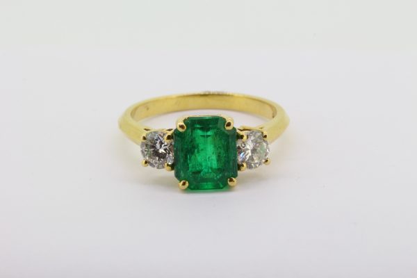 Emerald and diamond three stone ring in 18ct yellow gold