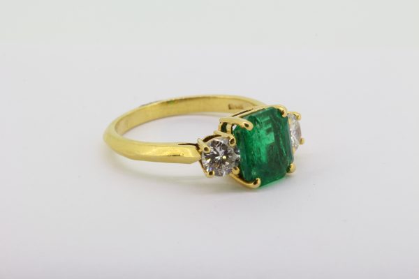 Emerald and diamond three stone ring in 18ct yellow gold