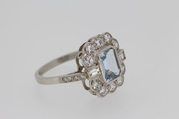 Aquamarine and Diamond Cluster Dress Ring; central 1.10ct emerald-cut aquamarine surrounded by 1cts baguette and brilliant-cut diamonds, in 18ct white gold