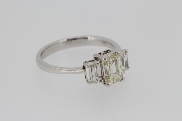 Emerald Cut Diamond Three Stone Engagement Ring; central 1.15ct emerald-cut diamond flanked by 0.60cts baguette-cut diamonds, in 18ct white gold