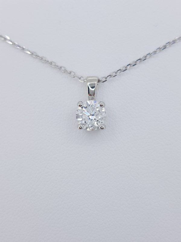Solitaire Diamond Pendant with Chain; 0.80ct round brilliant-cut diamond, four-claw set in 18ct white gold, on 18ct white gold trace chain